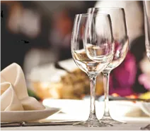 Table with wine glasses and plates at AIPL DreamCity Ludhiana