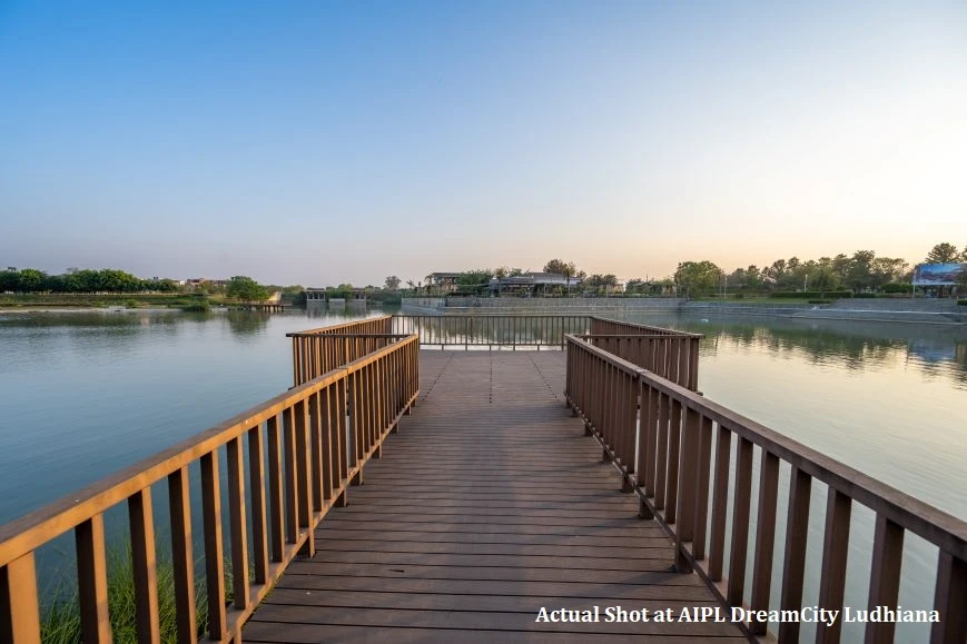 Wooden bridge leading to lake at sunset in AIPL DreamCity township project, Ludhiana Punjab