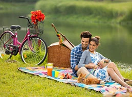 Couple sits by a AIPL DreamCity Ludhiana lakecity enjoying serene surroundings of in premier township project in Ludhiana