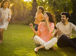 Family enjoying the sun on the grass at AIPL DreamCity Ludhiana township project in Ludhiana Punjab.