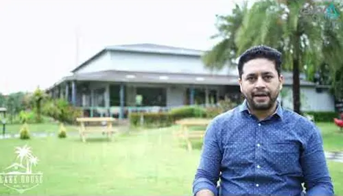 Man stands on lawn in front of his owned property at AIPL DreamCity township project, Ludhiana